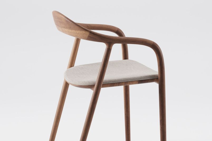 Neva chair in European walnut, white pigmented oil and fabric upholstery.